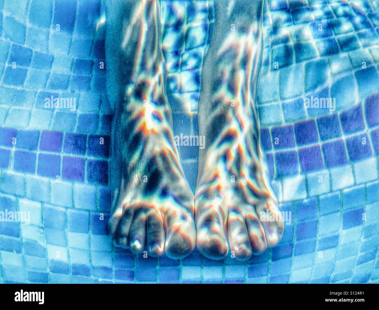 Summer fun. Feet in a swimming pool. - Smartphone Captured Stock Image