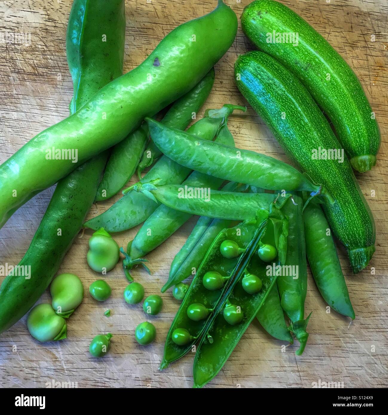Fresh peas courgettes and broad beans picked from the vegetable garden Stock Photo