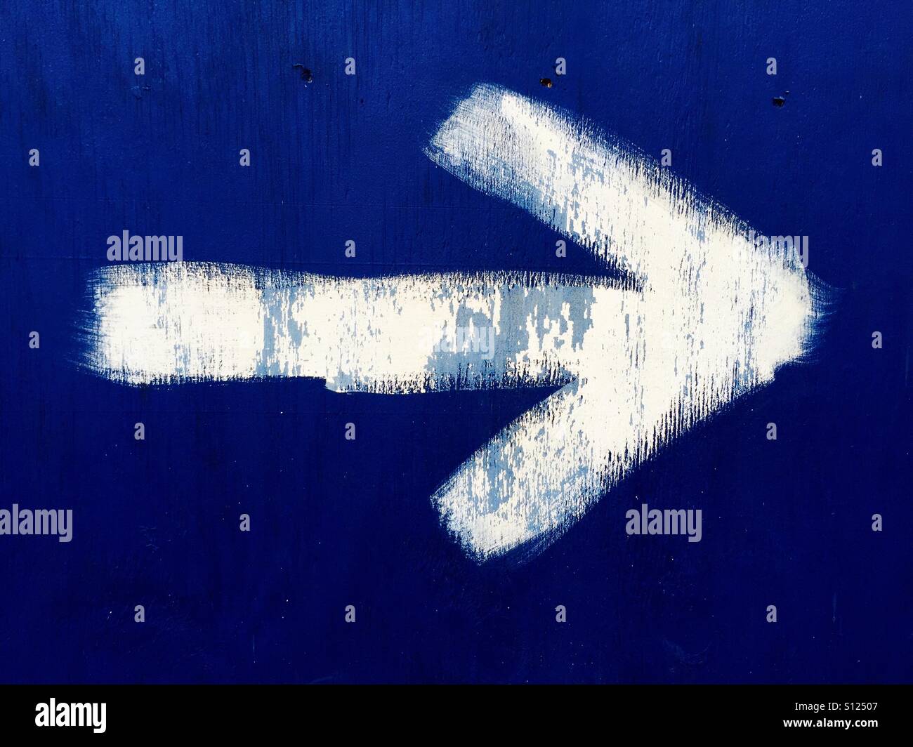 White arrow on blue background Stock Photo Alamy