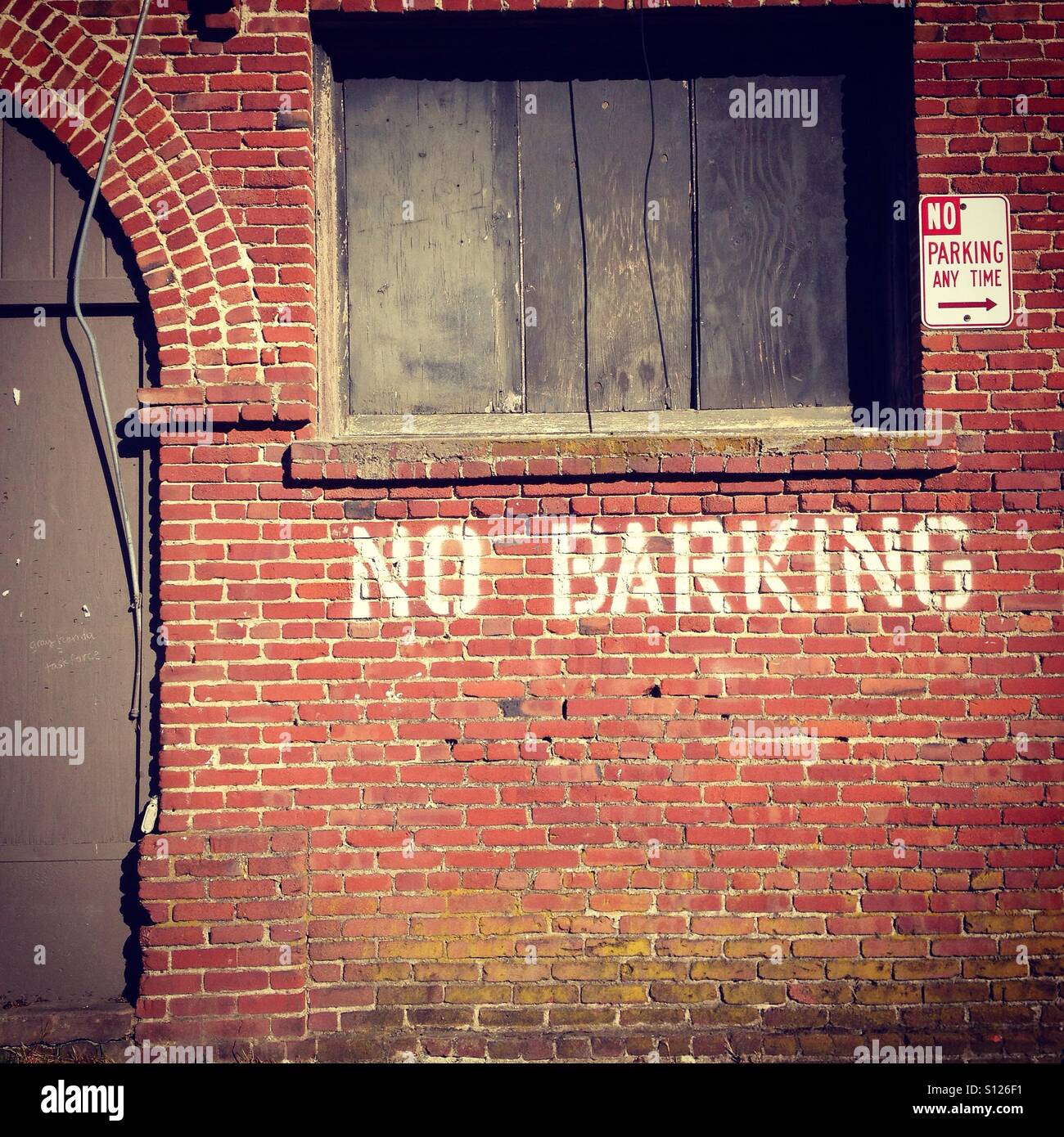 No Barking stenciled on a Red Brick building in Point Reyes Station, California. - Smartphone Captured Stock Image