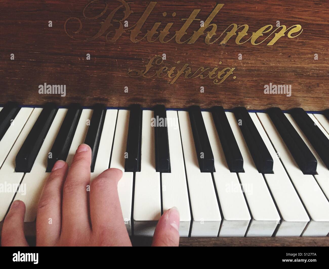 Hand on piano keys Stock Photo