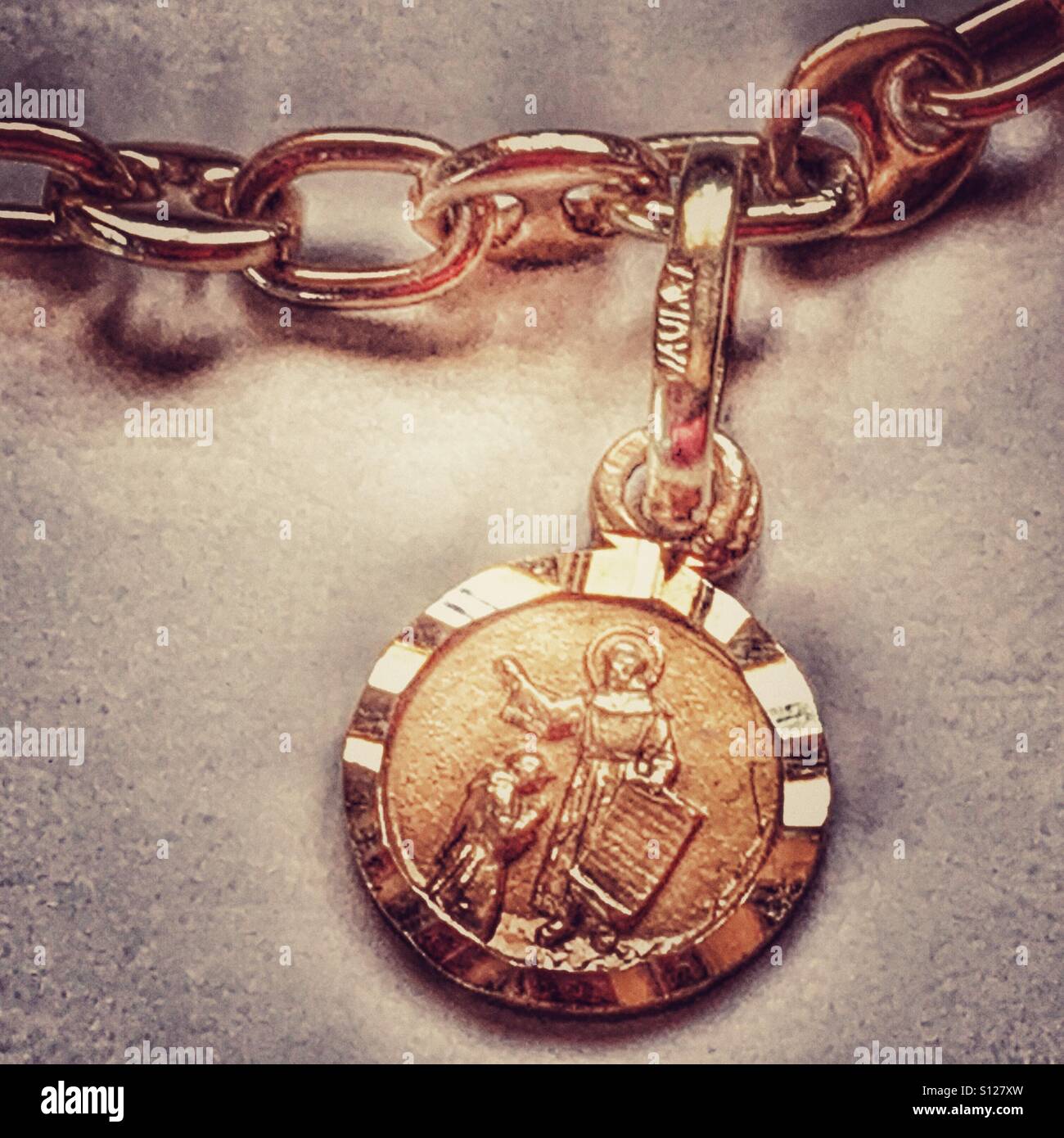 A gold charm bracelet with numerous gold charms Stock Photo - Alamy