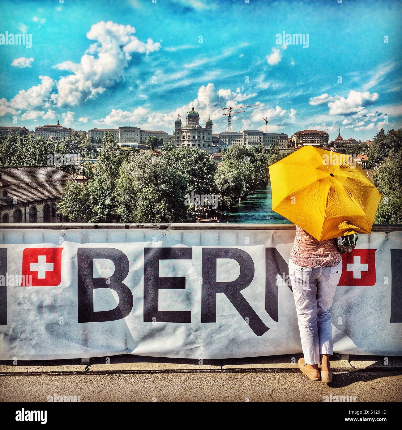 Woman with yellow umbrella enjoys panoramic view of Berne - Smartphone Captured Stock Image