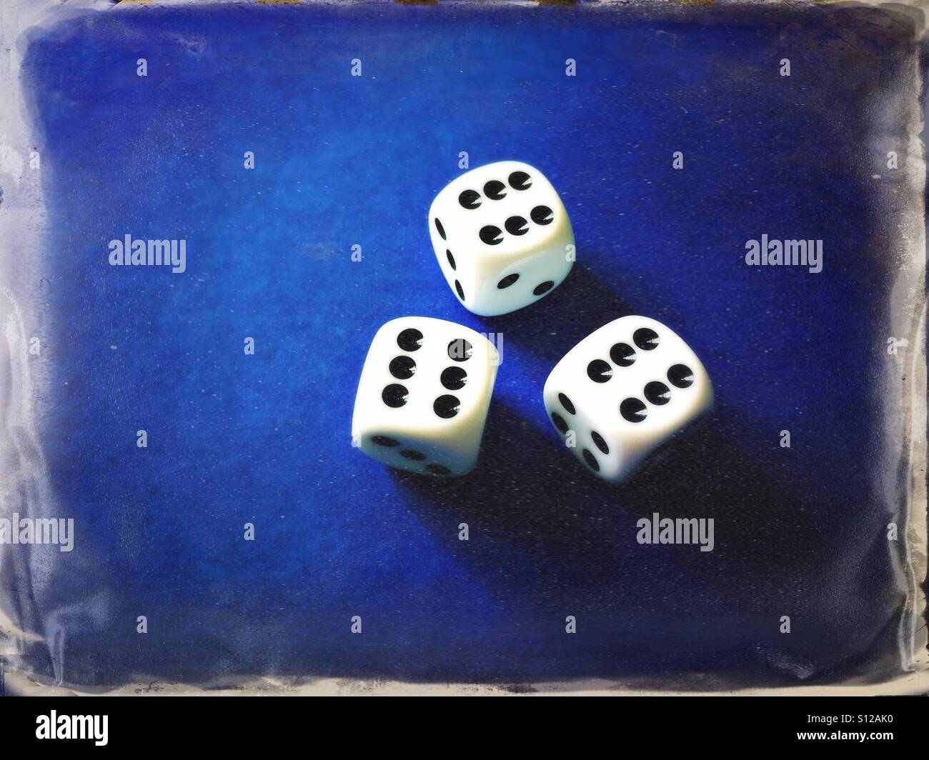 Three white dices on grungy blue background - Smartphone Captured Stock Image