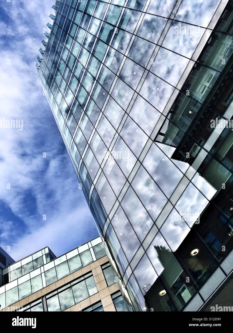 Sky reflection in a glass building in Manchester - Smartphone Captured Stock Image