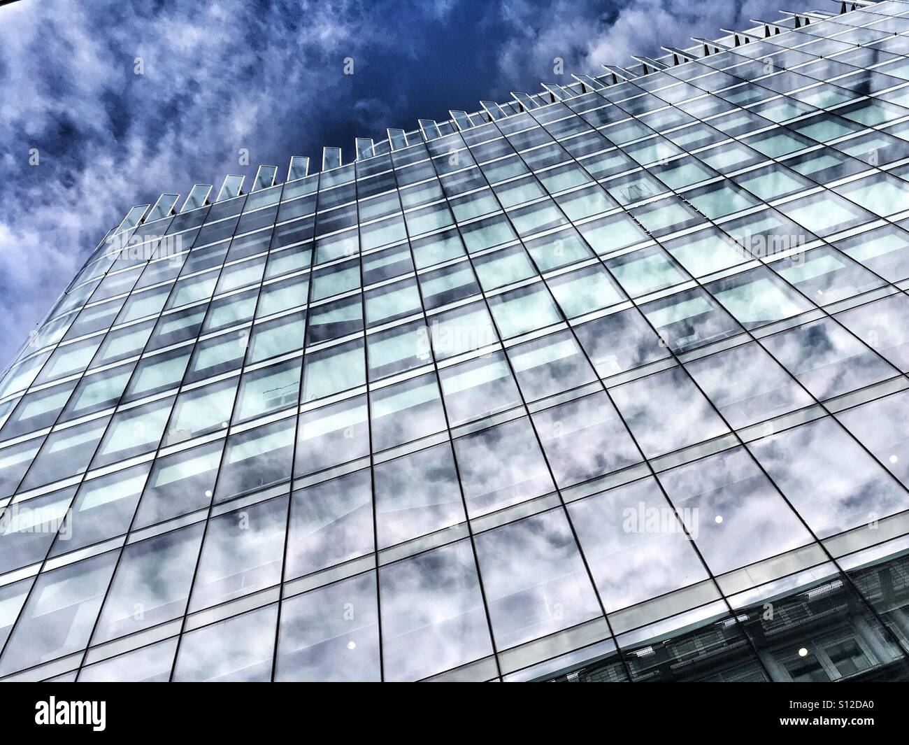 Sky reflection in a glass building in Manchester - Smartphone Captured Stock Image