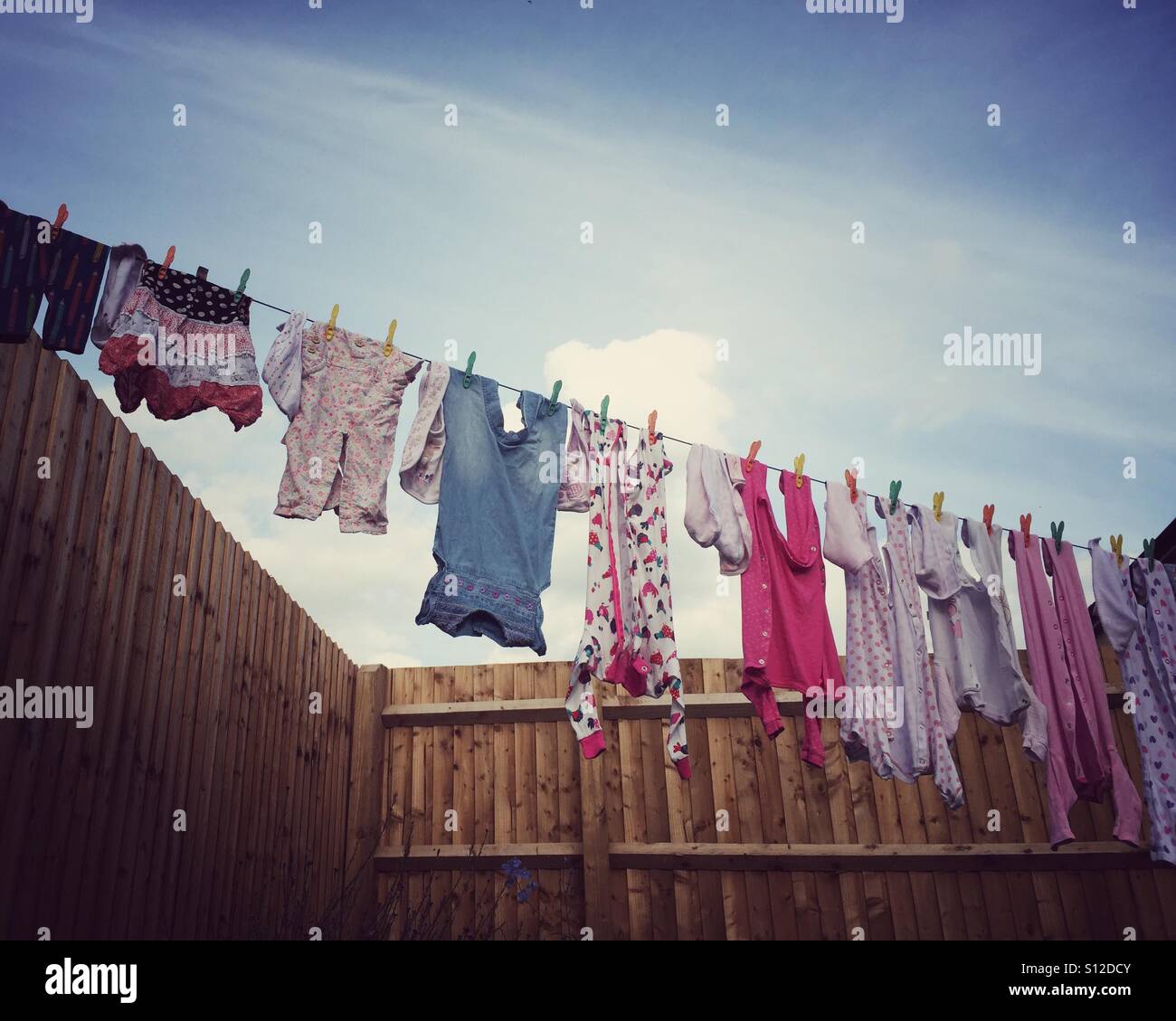 Baby clothes on washing line hires stock photography and images Alamy