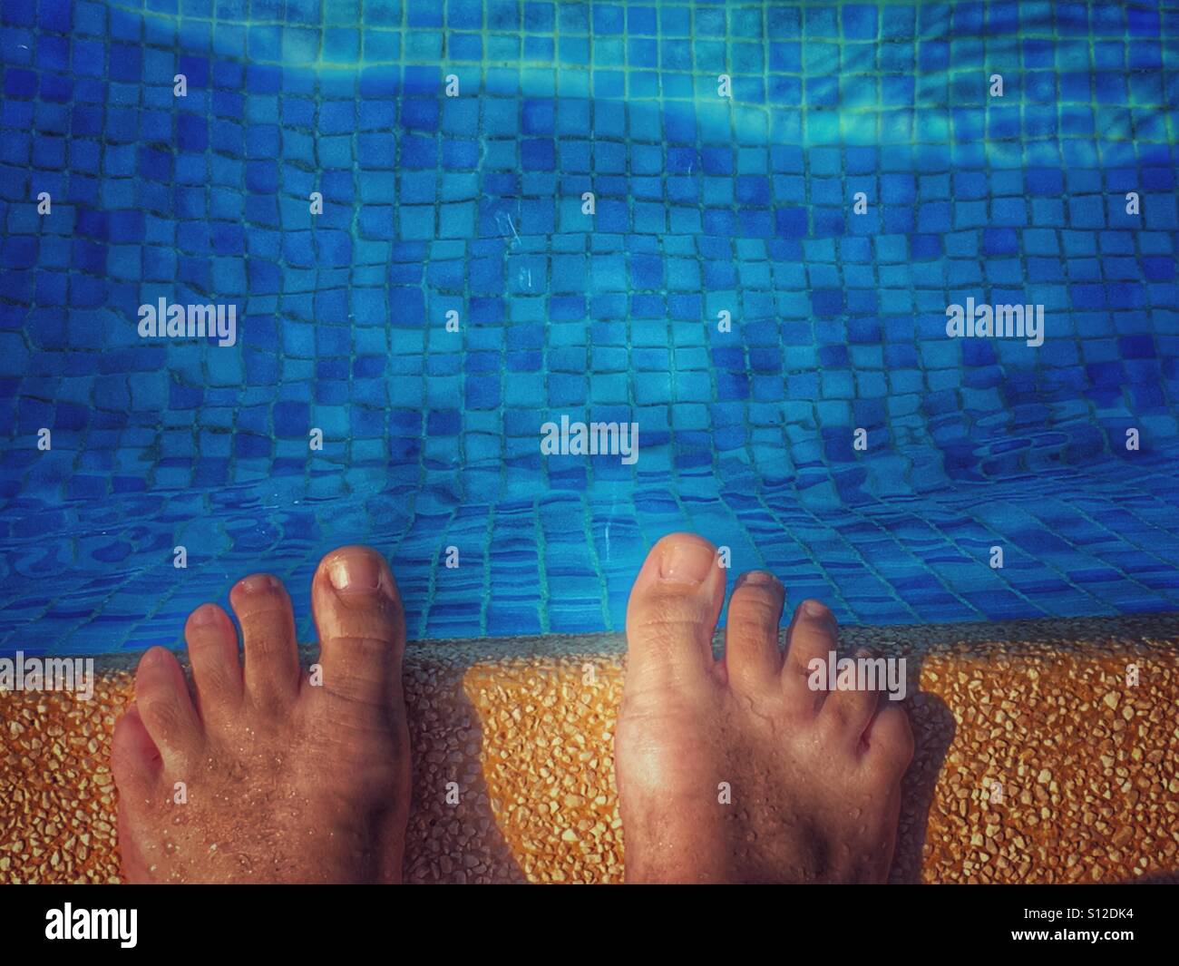 POV feet on the edge of a swimming pool Stock Photo - Alamy