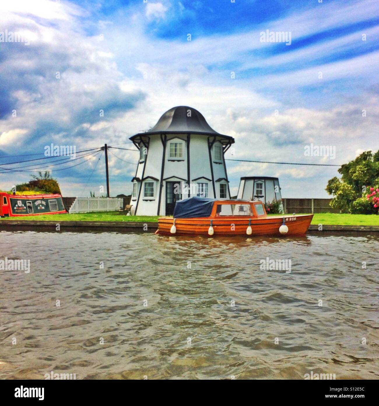 A riverside round house on the River Thurne at Potter Heigham on the Norfolk Broads Norfolk England UK Stock Photo