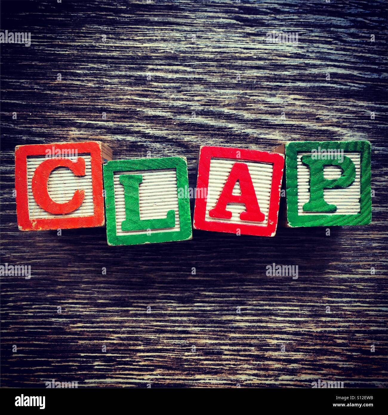 CLAP word written with wood block letter toys - Smartphone Captured Stock Image