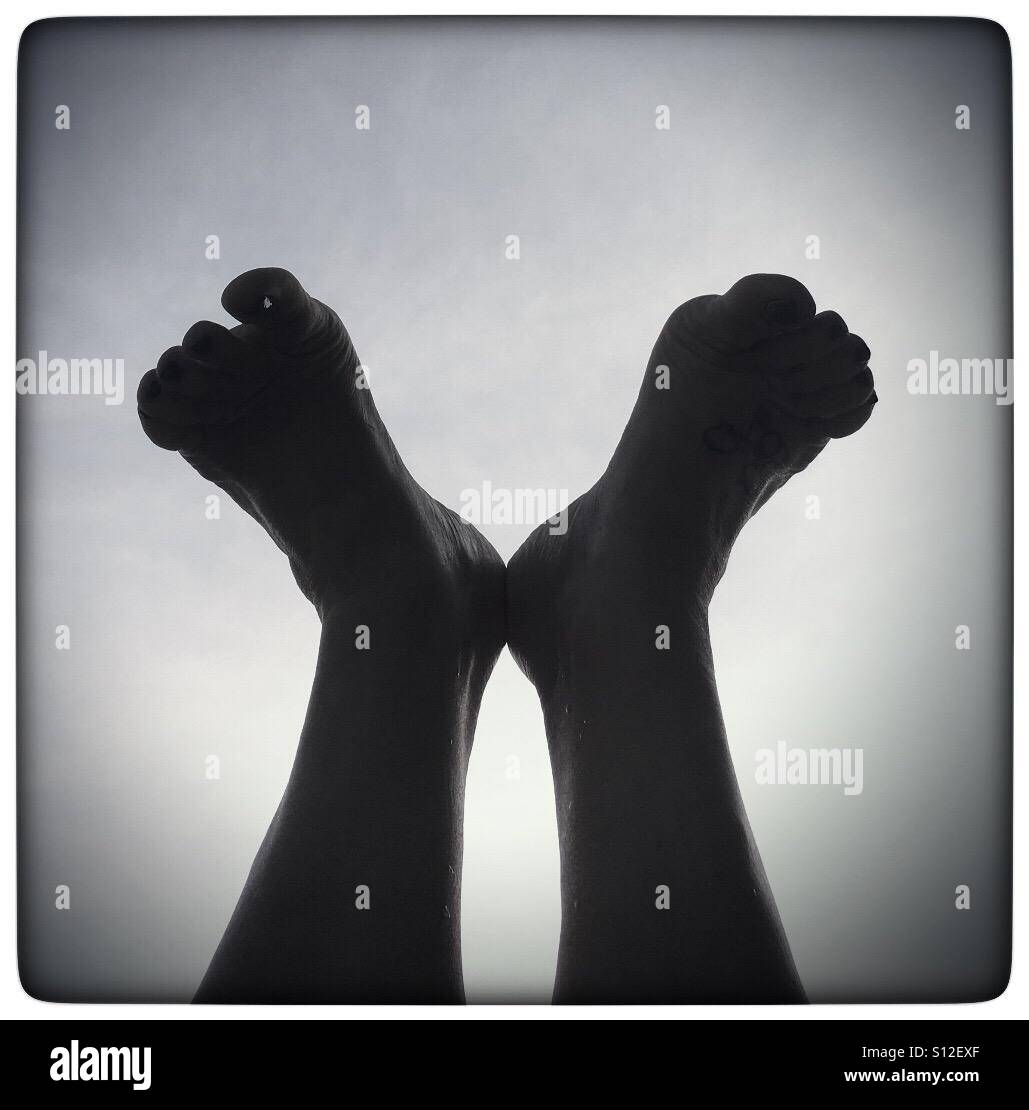 Silhouette of feet up on the air in black and white Stock Photo
