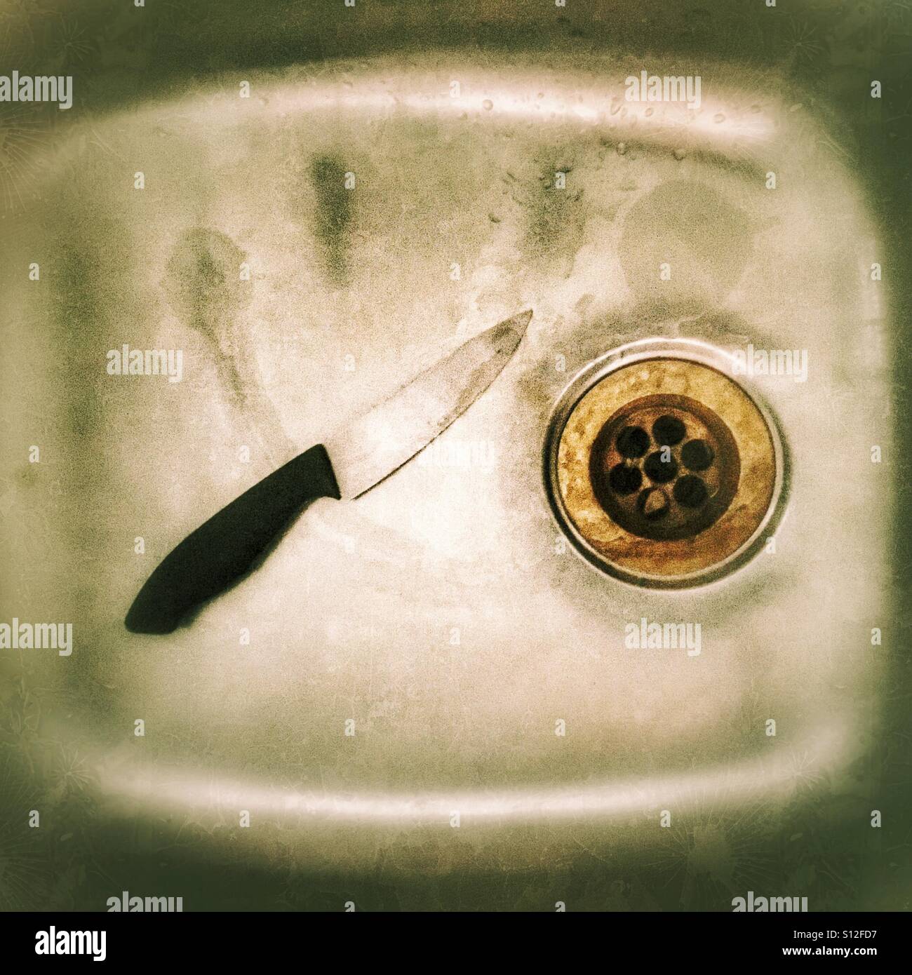 Knife in an aluminium sink Stock Photo Alamy