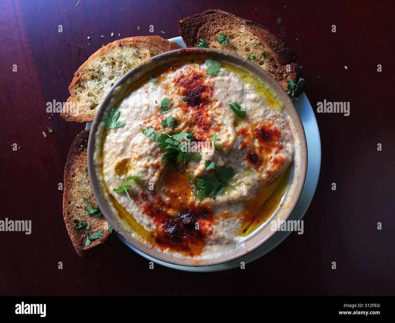 Humus with spicy pepper and bread Stock Photo