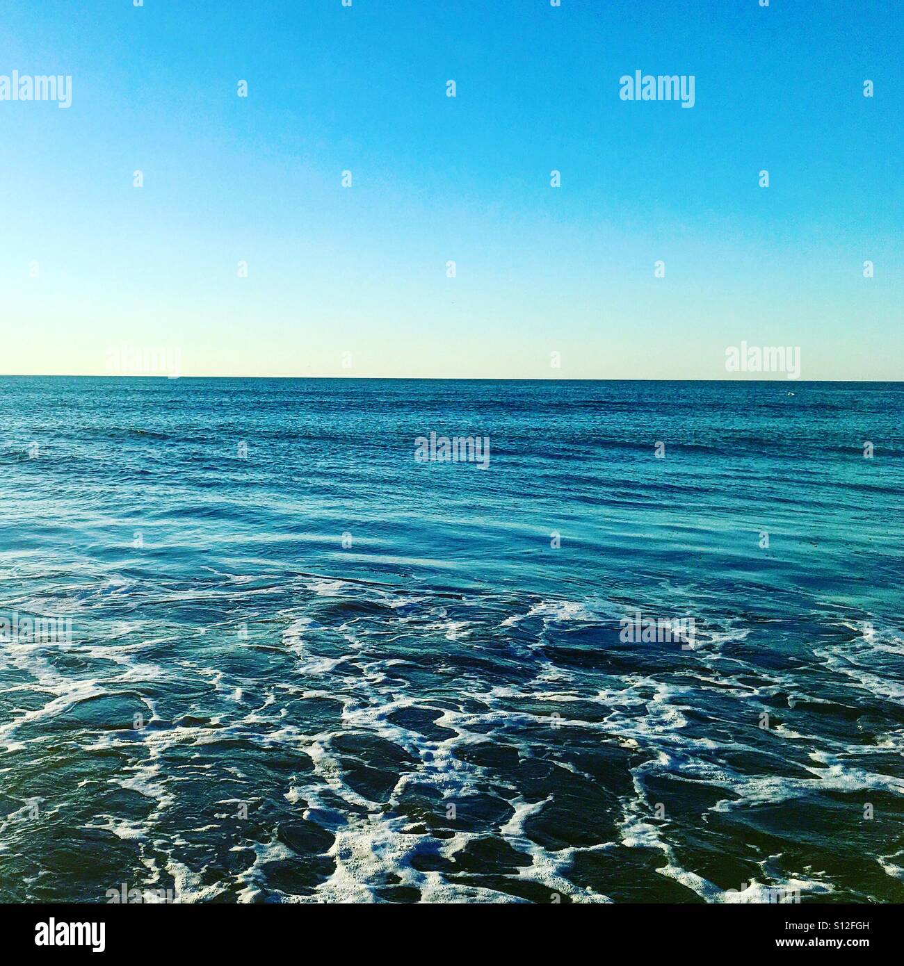 Blue Infinite Sea With Wake In The Foreground Stock Photo Alamy