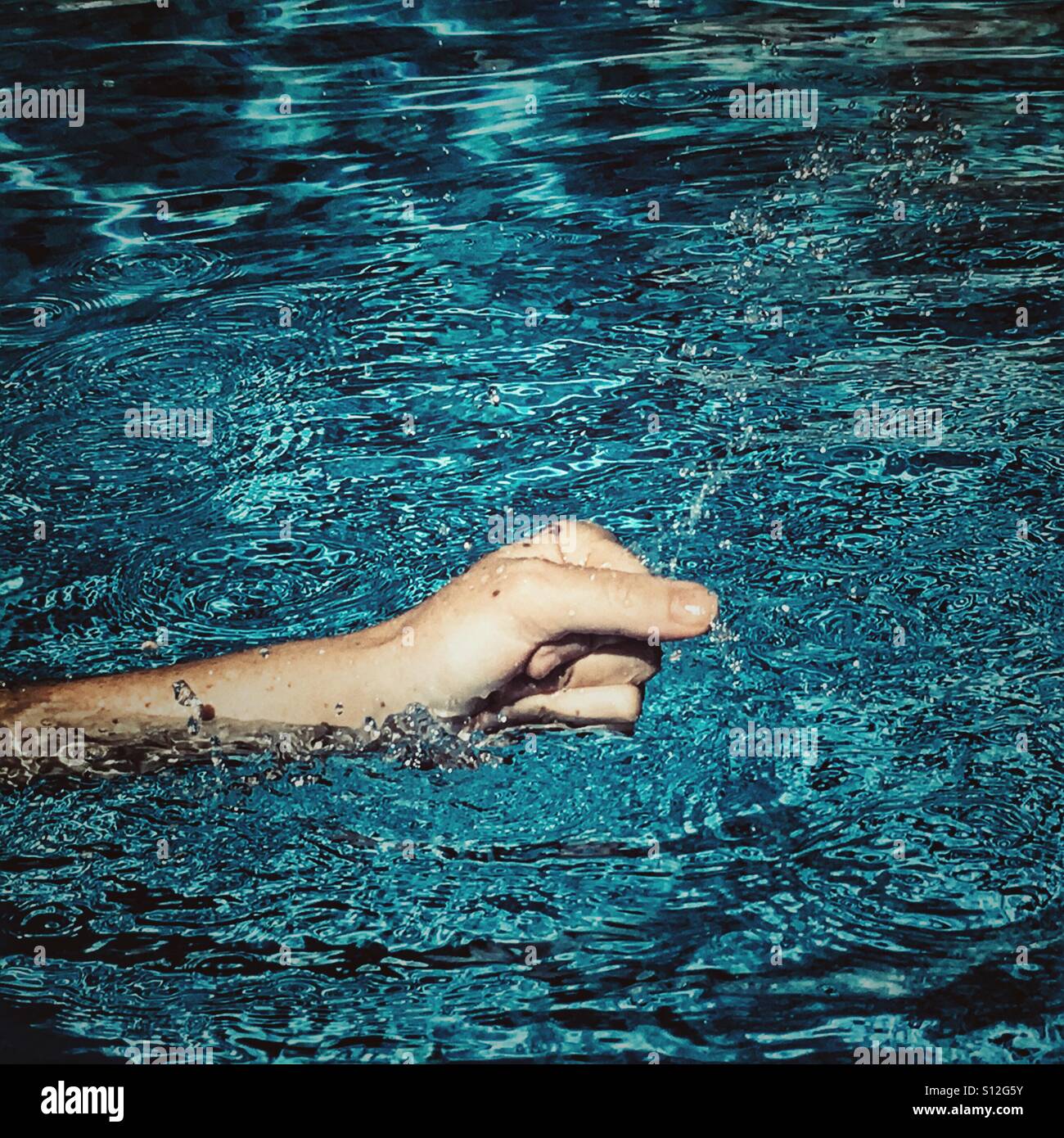 Splashing water in swimming pool. - Smartphone Captured Stock Image