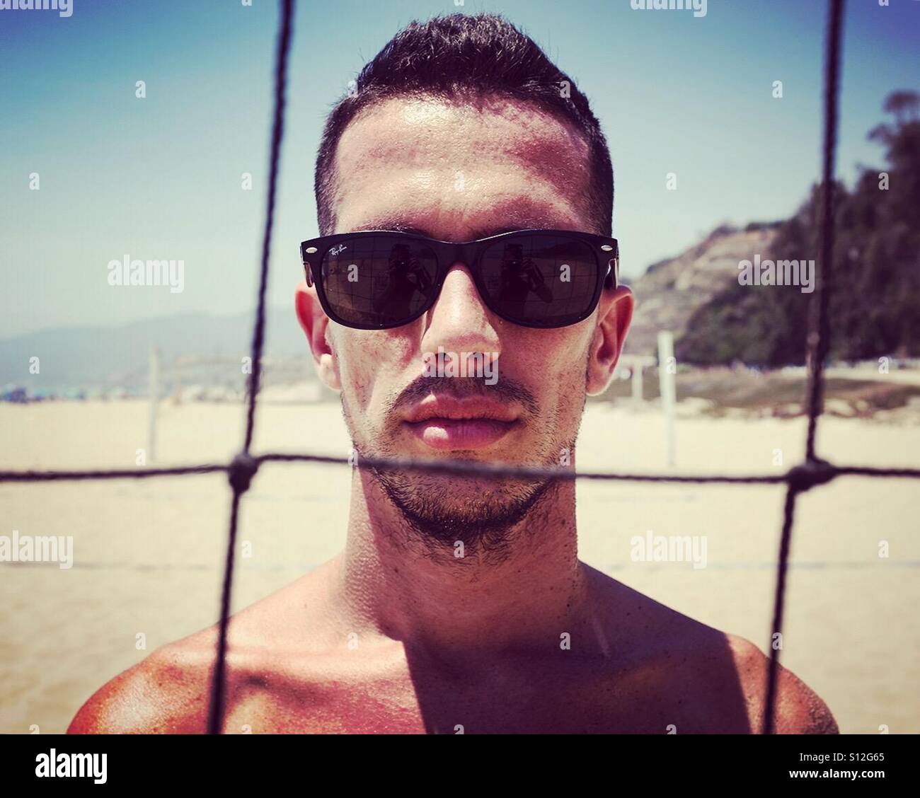 Man on beach - volleyball - Smartphone Captured Stock Image