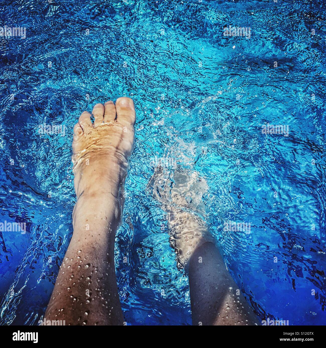 POV. Summer fun. Relaxing in swimming pool - Smartphone Captured Stock Image