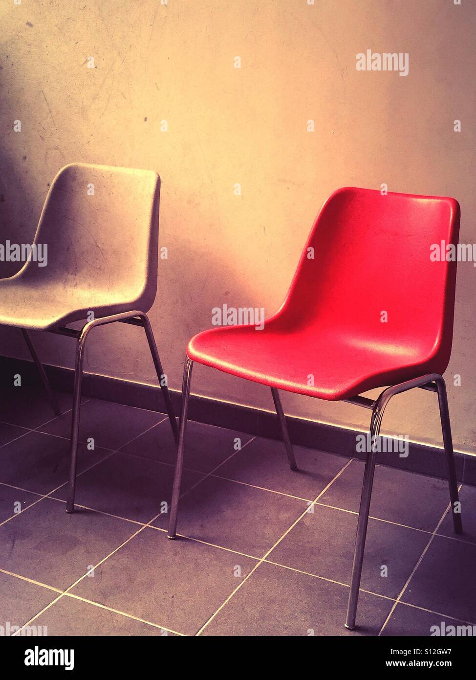 Lonely red chair in waiting room - Smartphone Captured Stock Image