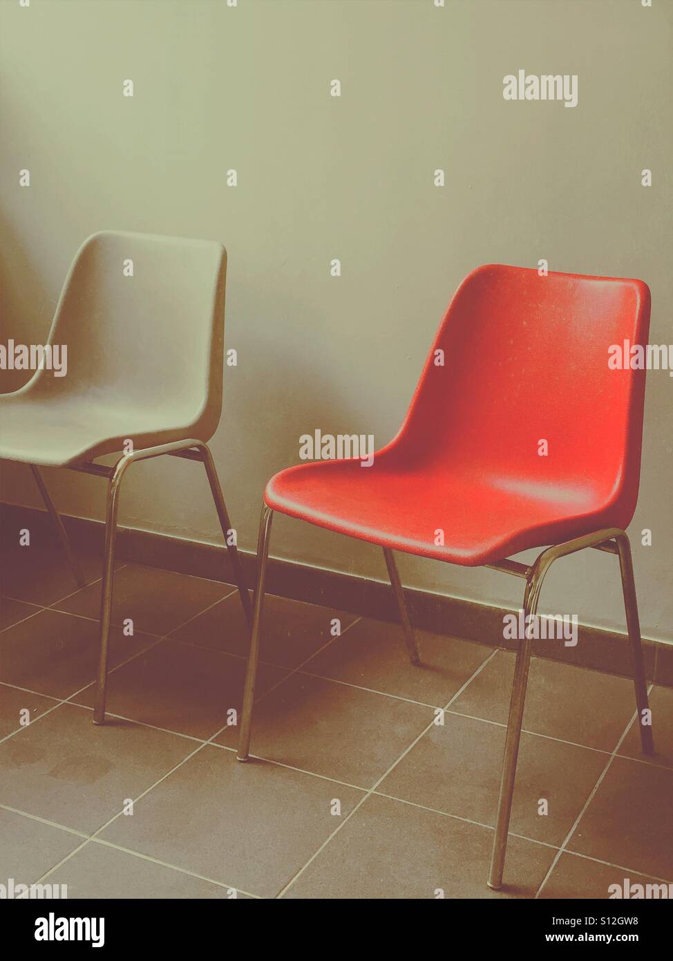 Lonely red chair in waiting room - Smartphone Captured Stock Image