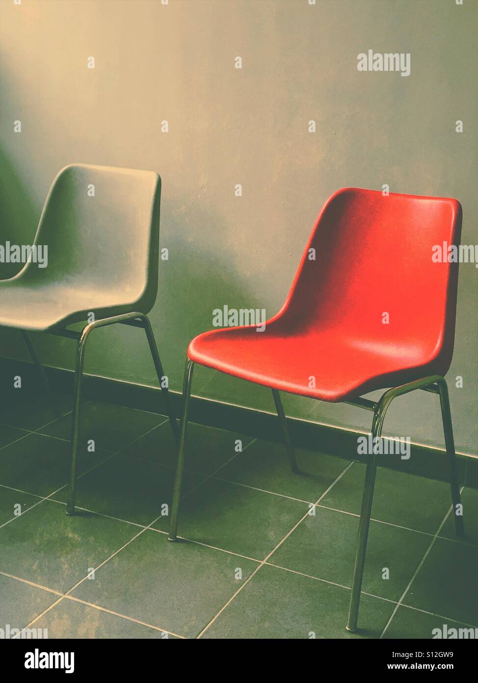 Lonely red chair in waiting room - Smartphone Captured Stock Image
