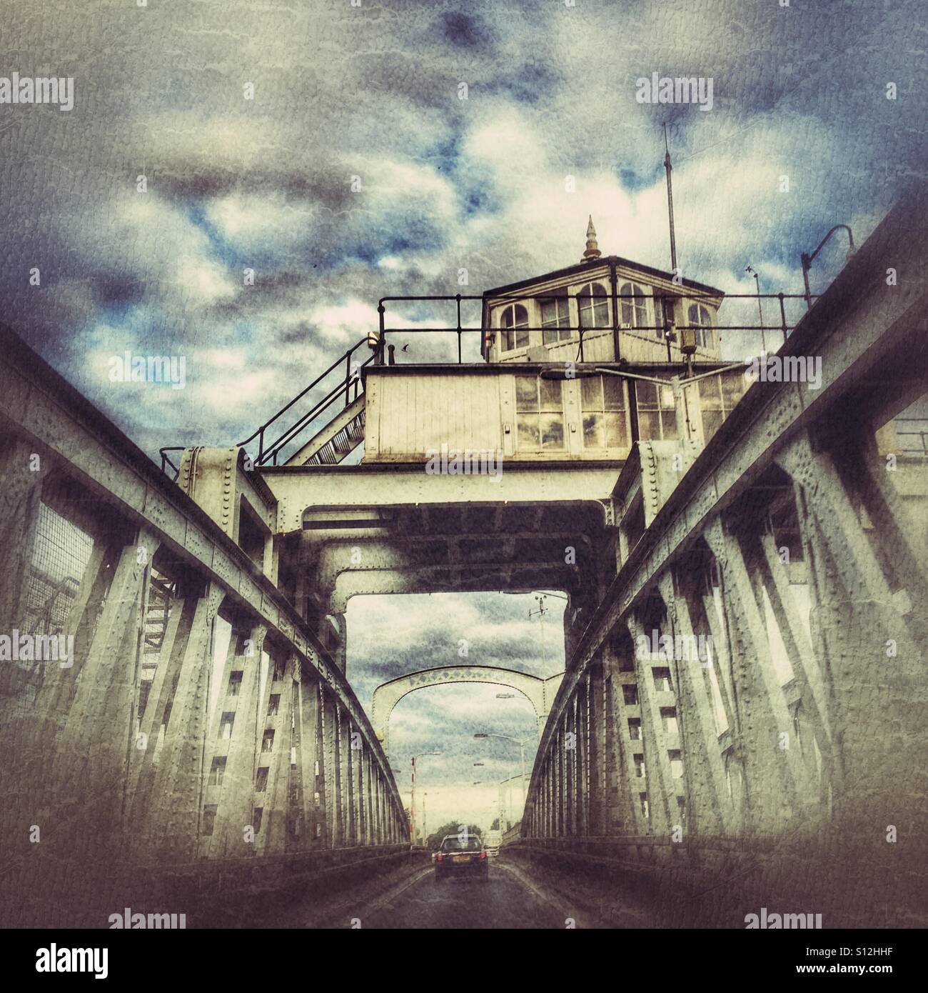 Symmetrical view of the Cross Keys Bridge over the River Nene at Sutton Bridge, Lincolnshire, showing industrial structure and dramatic sky. - Smartphone Captured Stock Image