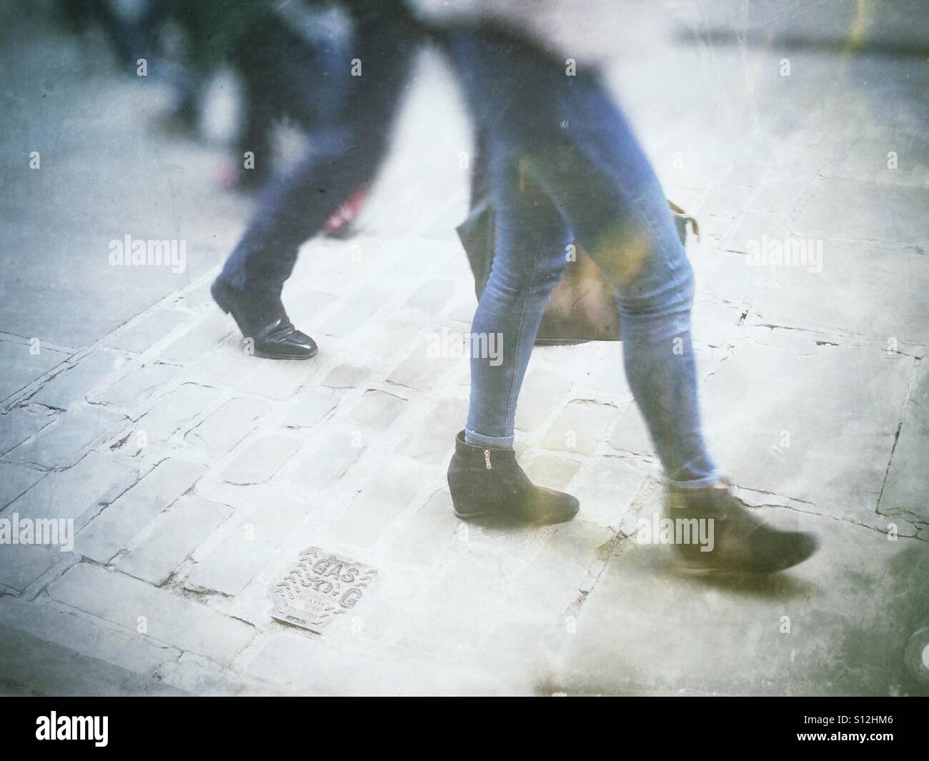 People walking along cobbled street England UK - Smartphone Captured Stock Image