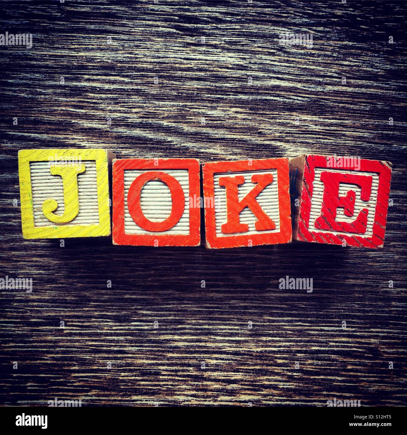 JOKE word written with wood block letter toys - Smartphone Captured Stock Image