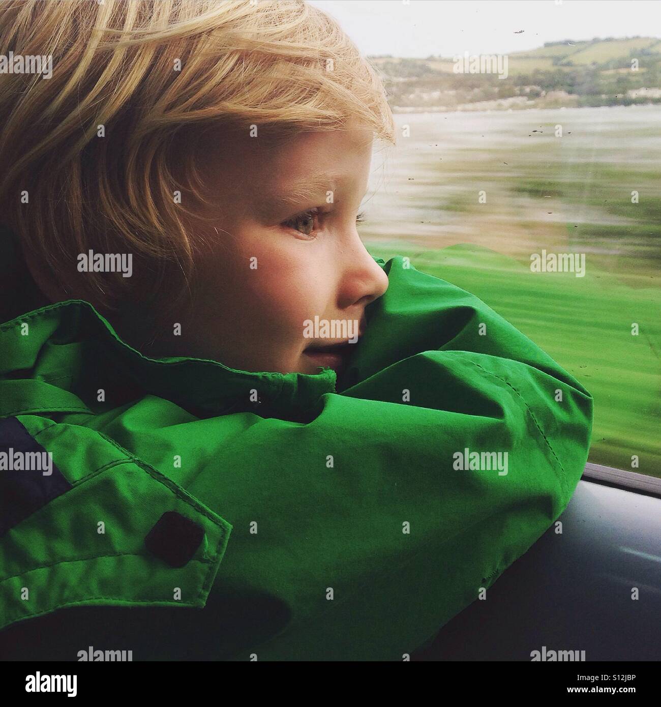 Boy looking out of a train window - Smartphone Captured Stock Image