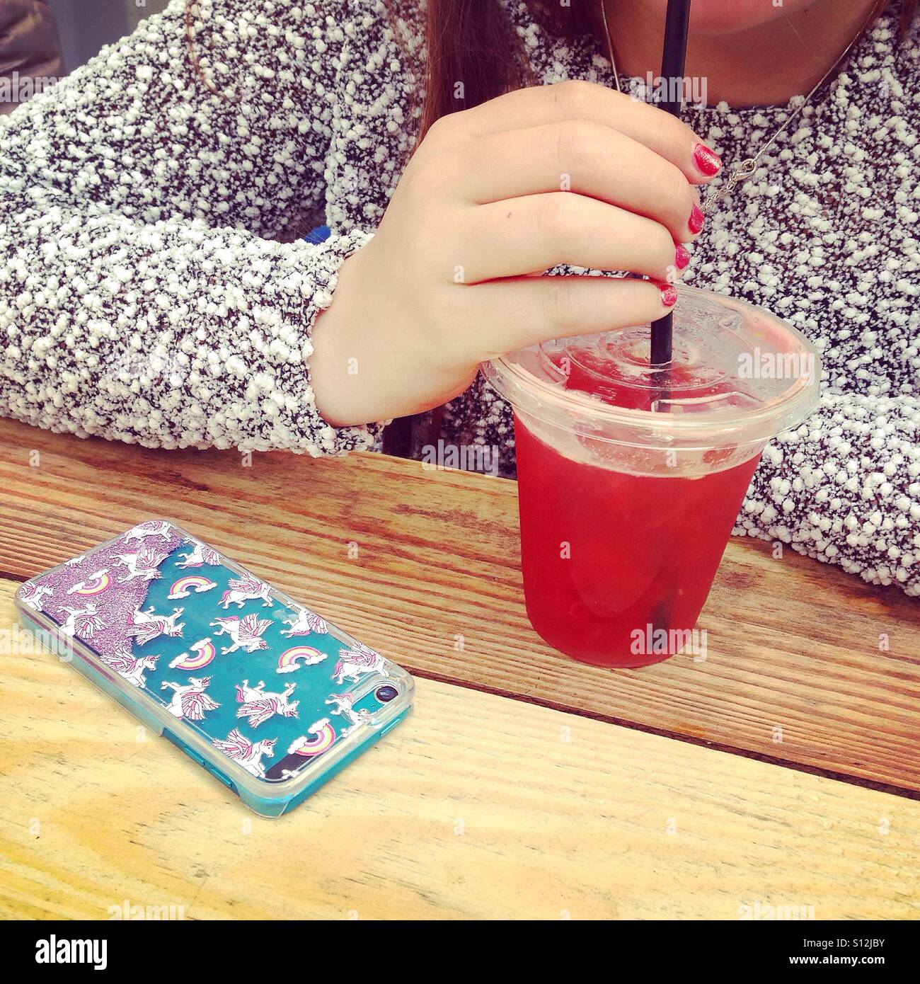 Teenager sipping juice - Smartphone Captured Stock Image