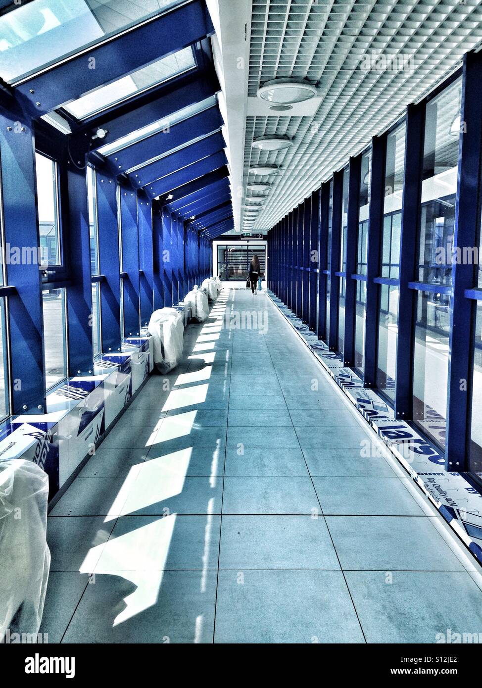 Woman working in a airport terminal during construction - Smartphone Captured Stock Image