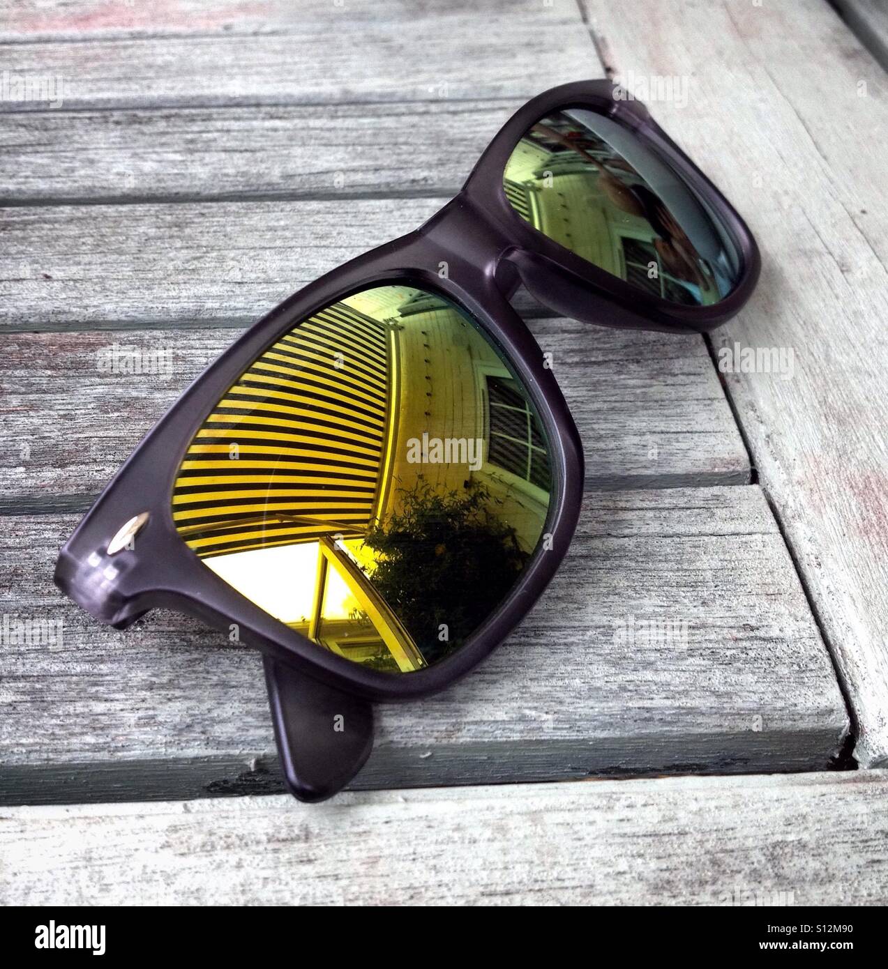 Sunglasses on a garden table. - Smartphone Captured Stock Image