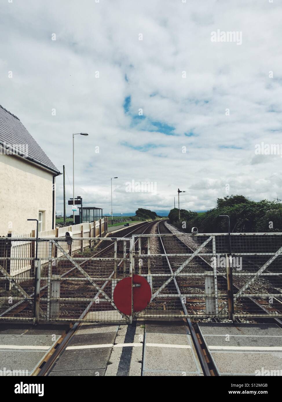 Level crossing at Ty Croes train station, Anglesey, North Wales - Smartphone Captured Stock Image