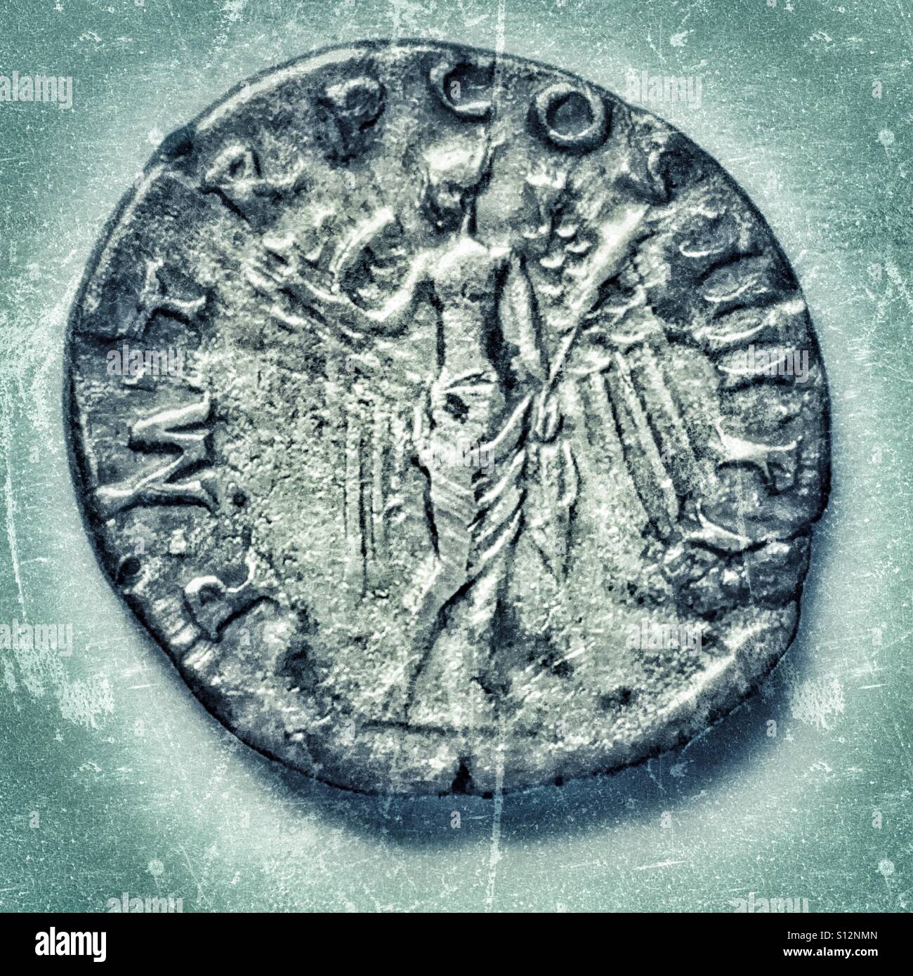 Roman silver denarius of Trajan, 98-117CE. Reverse. Winged Victory holding patera and palm. Inscription P M TR P COS III PP - Smartphone Captured Stock Image