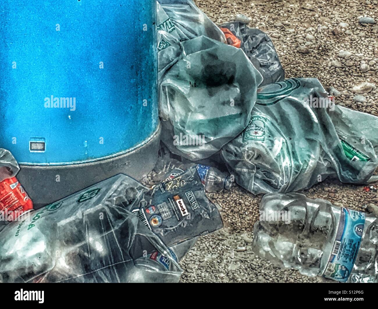 Overflowing rubbish bin on a beach. - Smartphone Captured Stock Image