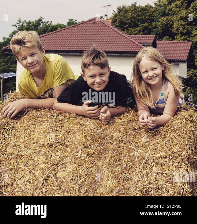 Three siblings enjoying their summer vacations at the polish country Stock Photo