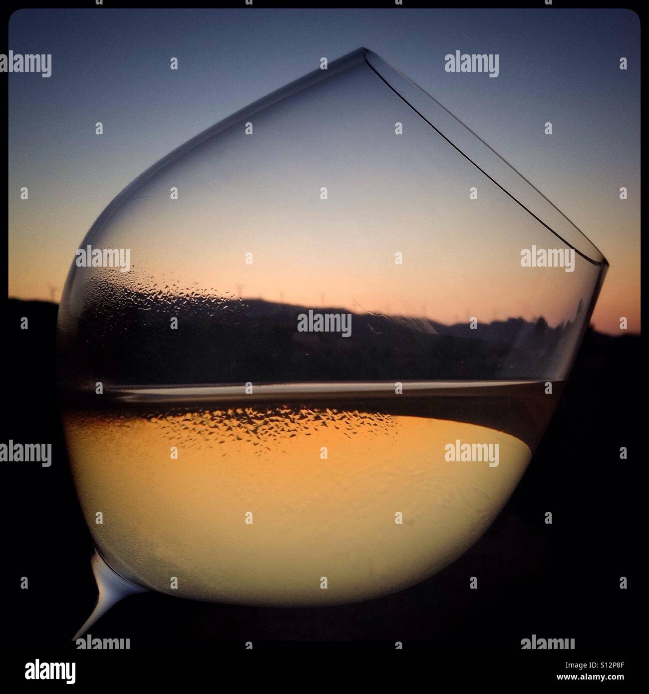 Sunset through a glass of white wine, Spain - Smartphone Captured Stock Image