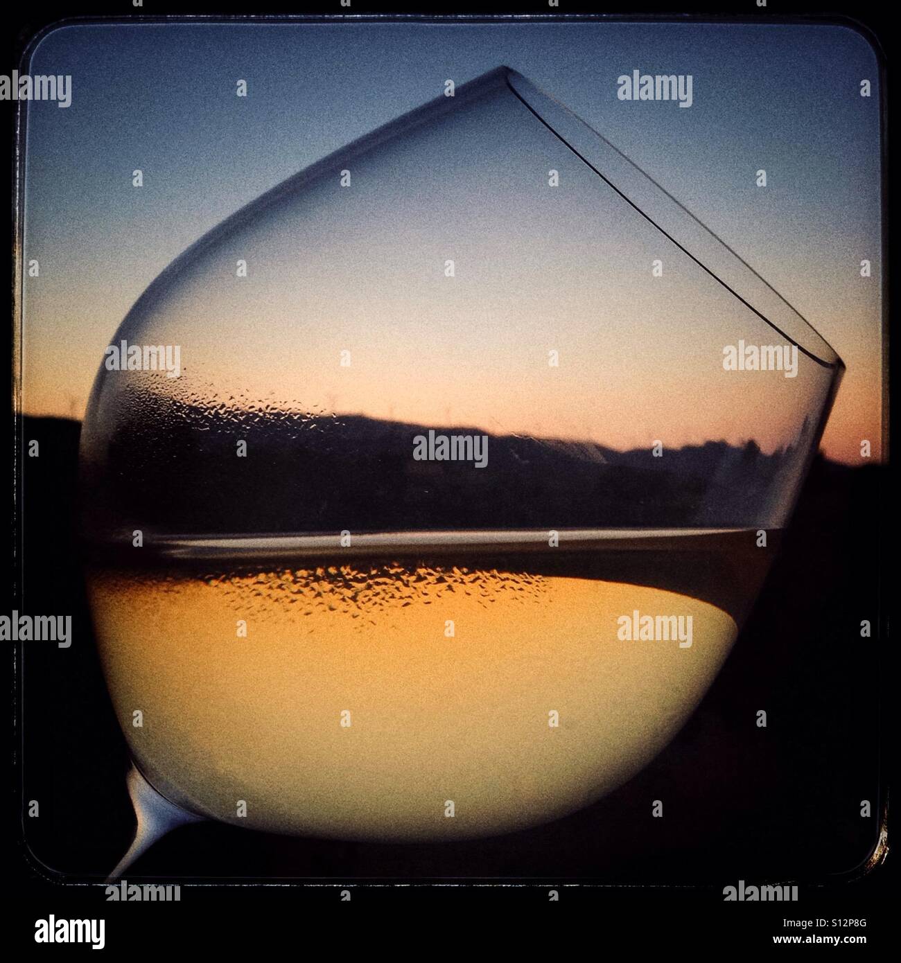 Sunset through a glass of white wine, Spain - Smartphone Captured Stock Image