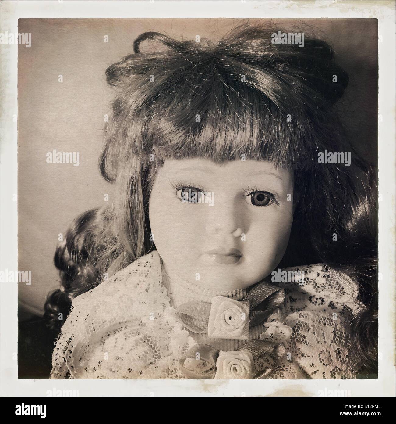 Face of china doll, in sepia colour Stock Photo