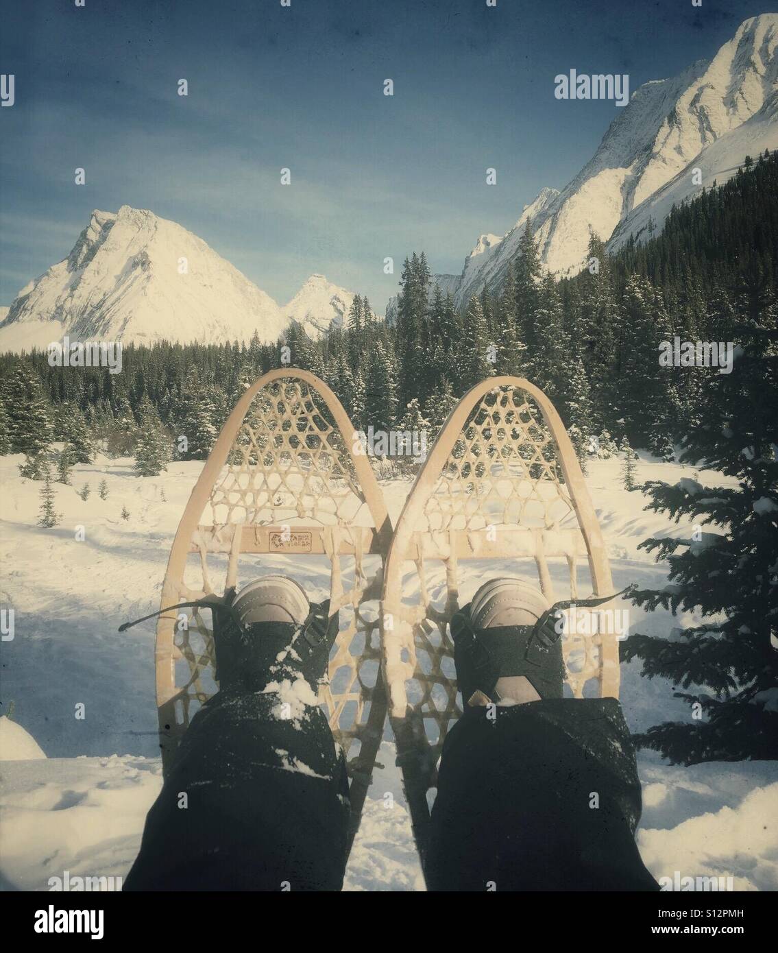 Snowshoes against a winter mountain scene. Stock Photo