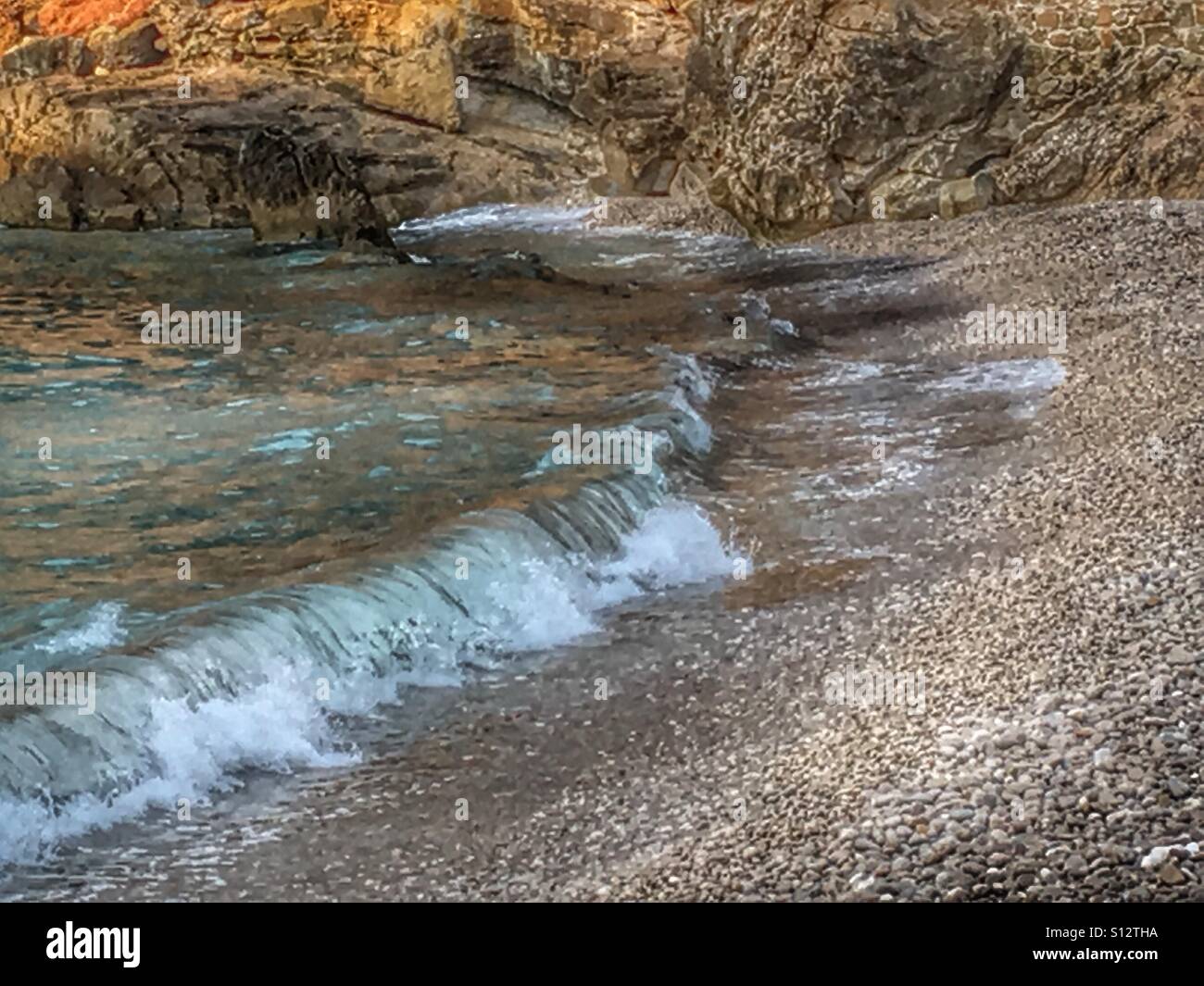 Waves breaking on Granadella beach, Alicante Province, Spain. Early morning light. - Smartphone Captured Stock Image