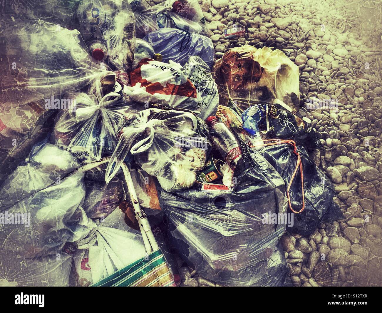 Piles of garbage on a pebble beach - Smartphone Captured Stock Image