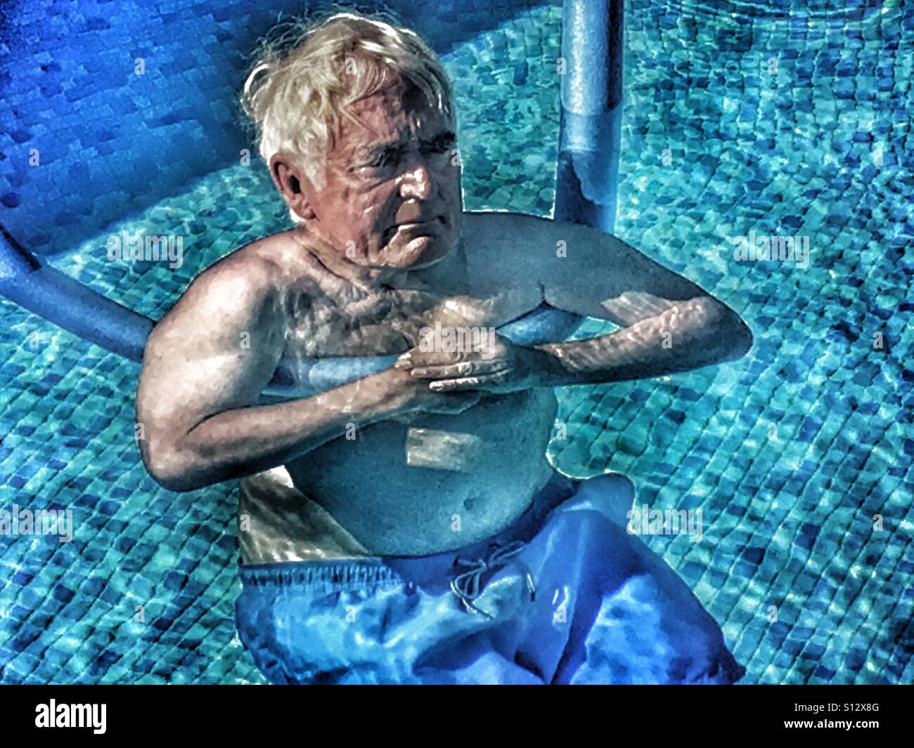 Elderly man in swimming pool Stock Photo