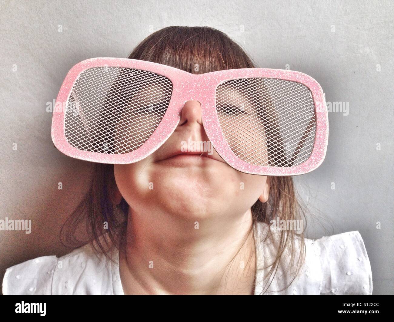 Young girl wearing oversized comedy glasses Stock Photo