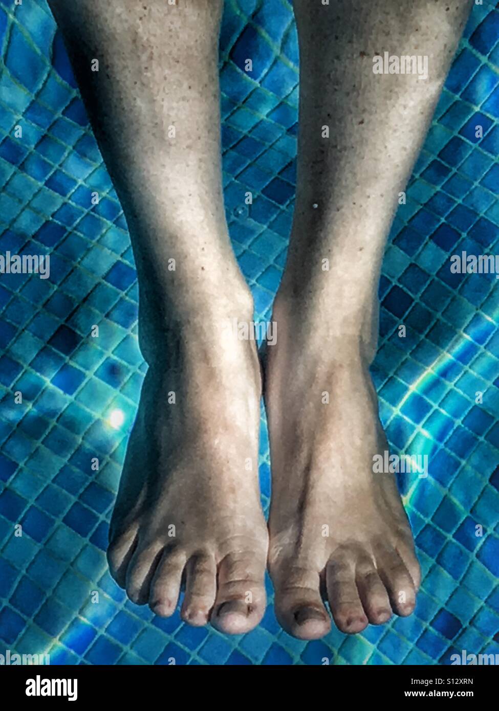Feet in swimming pool - Smartphone Captured Stock Image