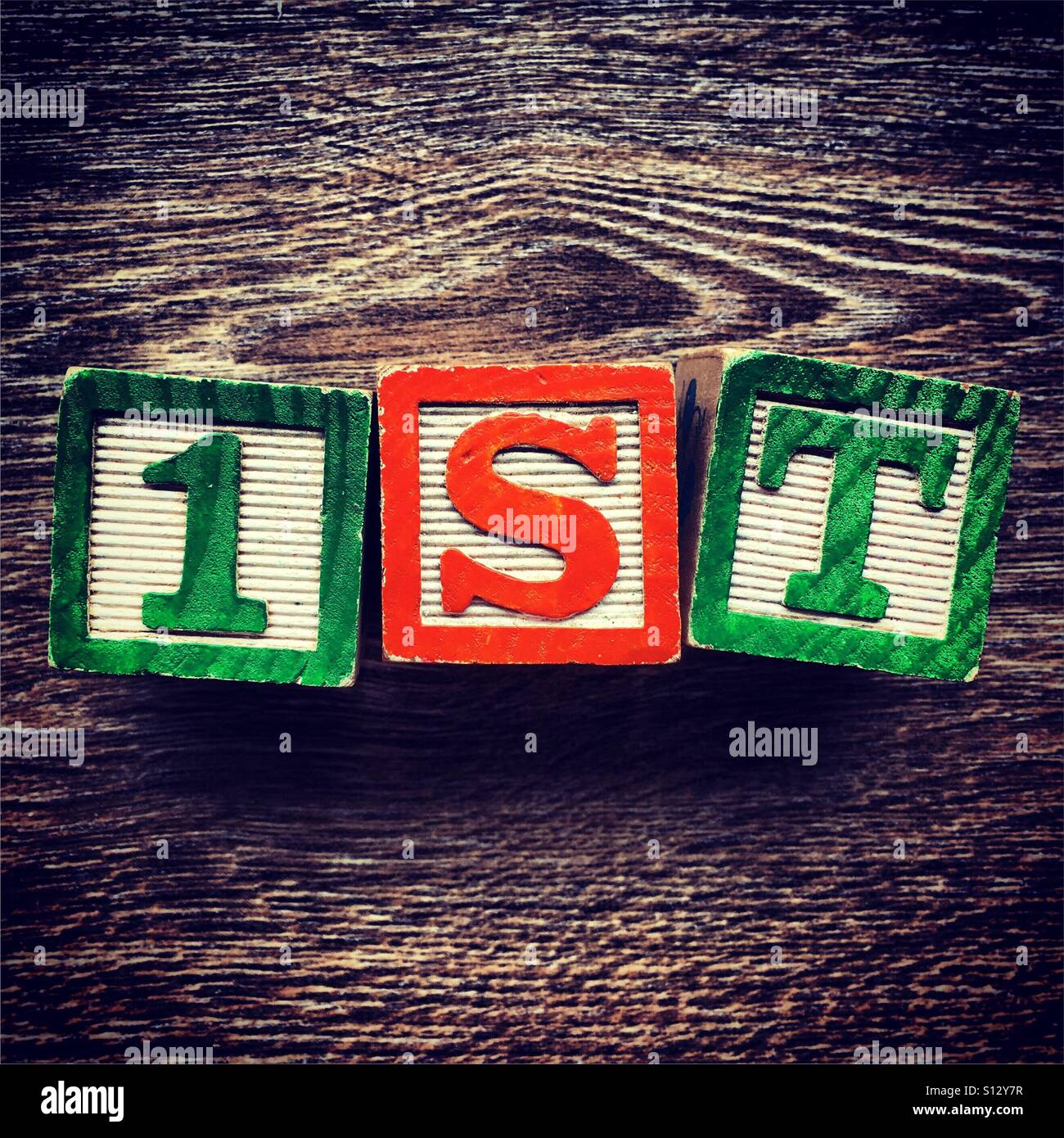 1ST word written with wood block letter toys - Smartphone Captured Stock Image
