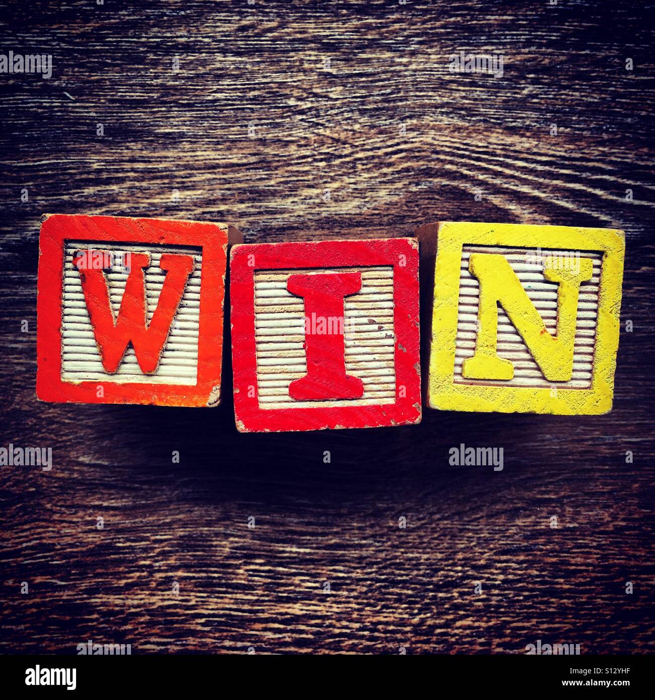 WIN word written with wood block letter toys - Smartphone Captured Stock Image