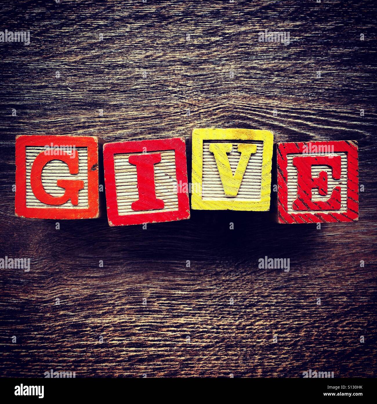 GIVE word written with wood block letter toys - Smartphone Captured Stock Image