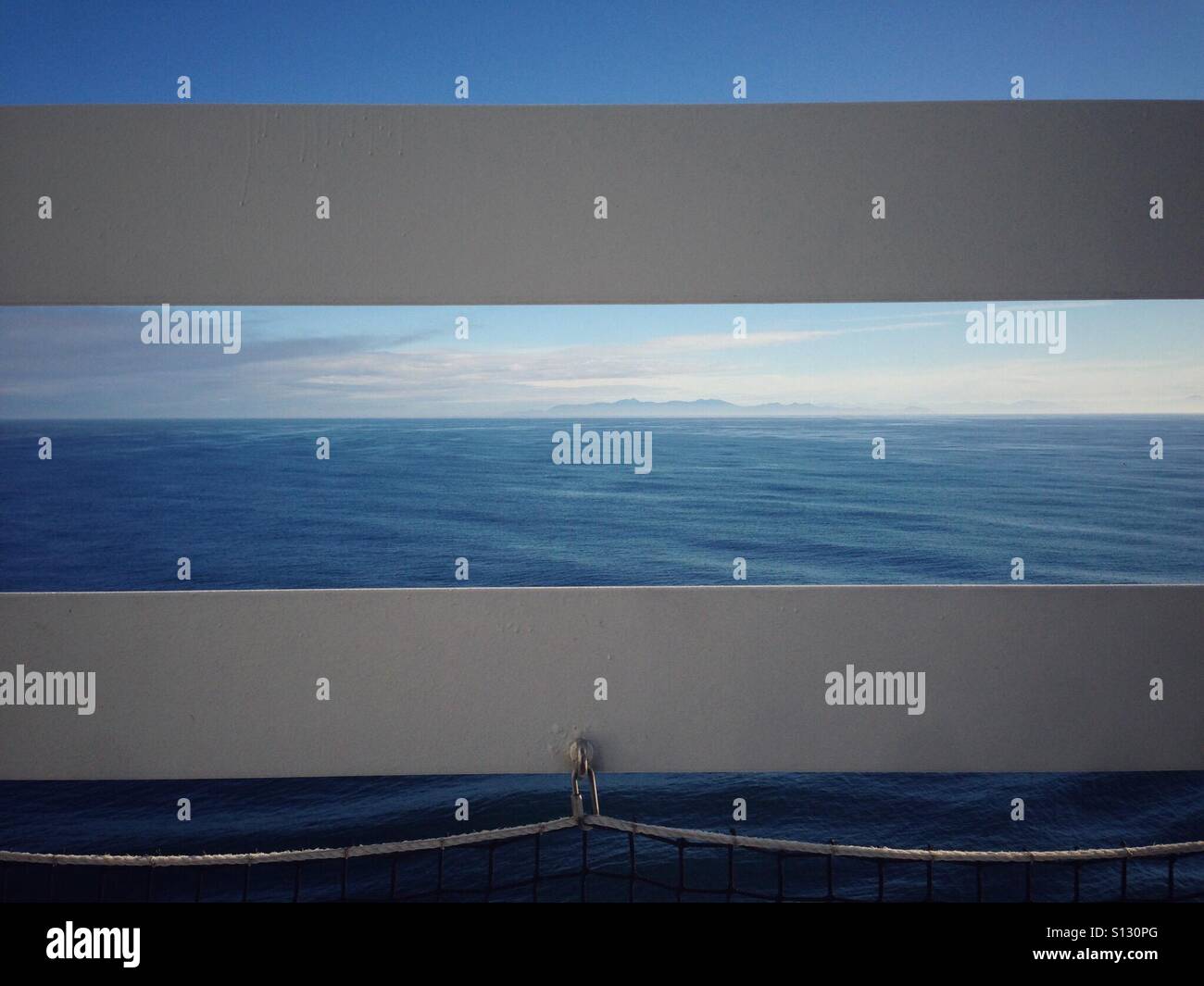 The Pacific coastline through the railing of a cruise ship Stock Photo ...