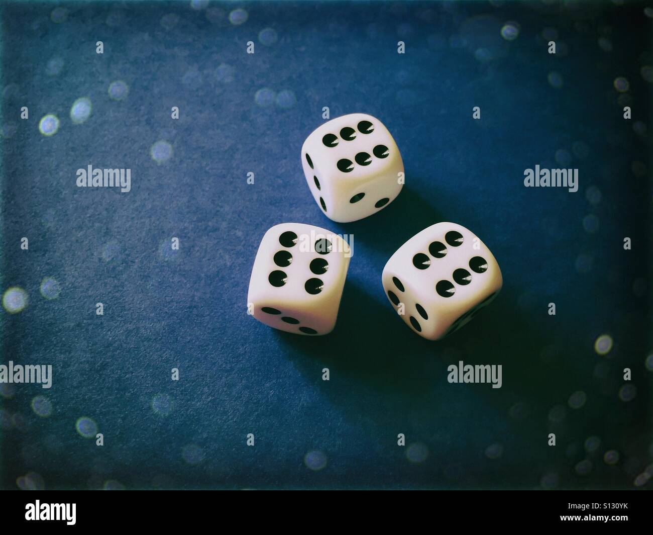Three white dices on blue background - Smartphone Captured Stock Image