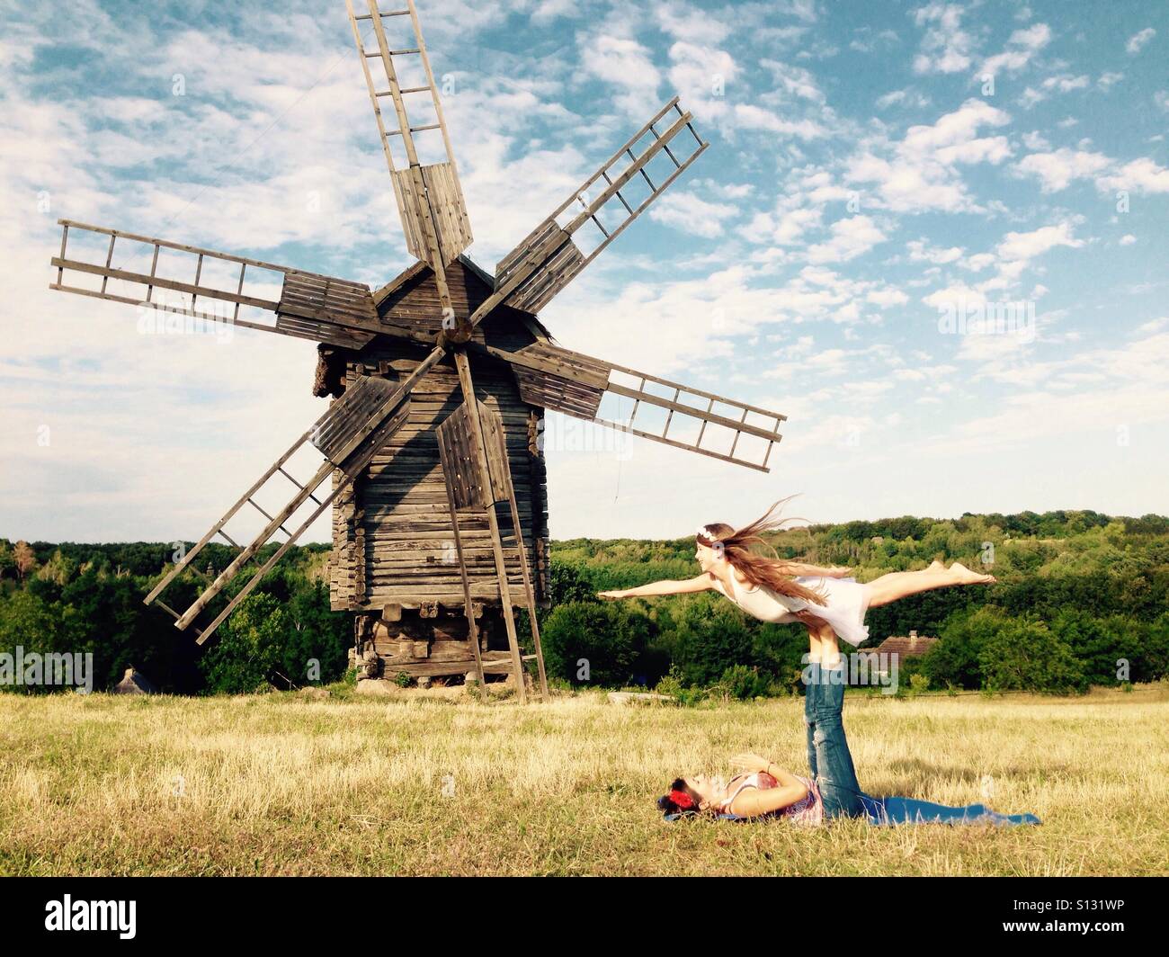 Acro yoga near windmill Stock Photo